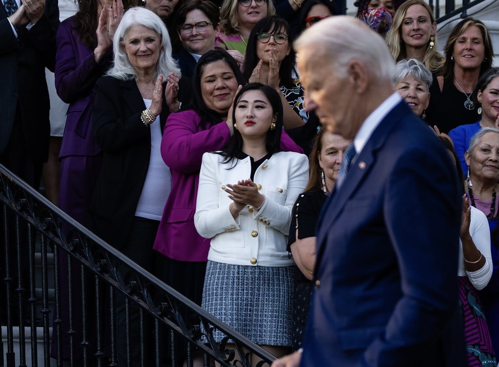 Woman holding up hand with X mark